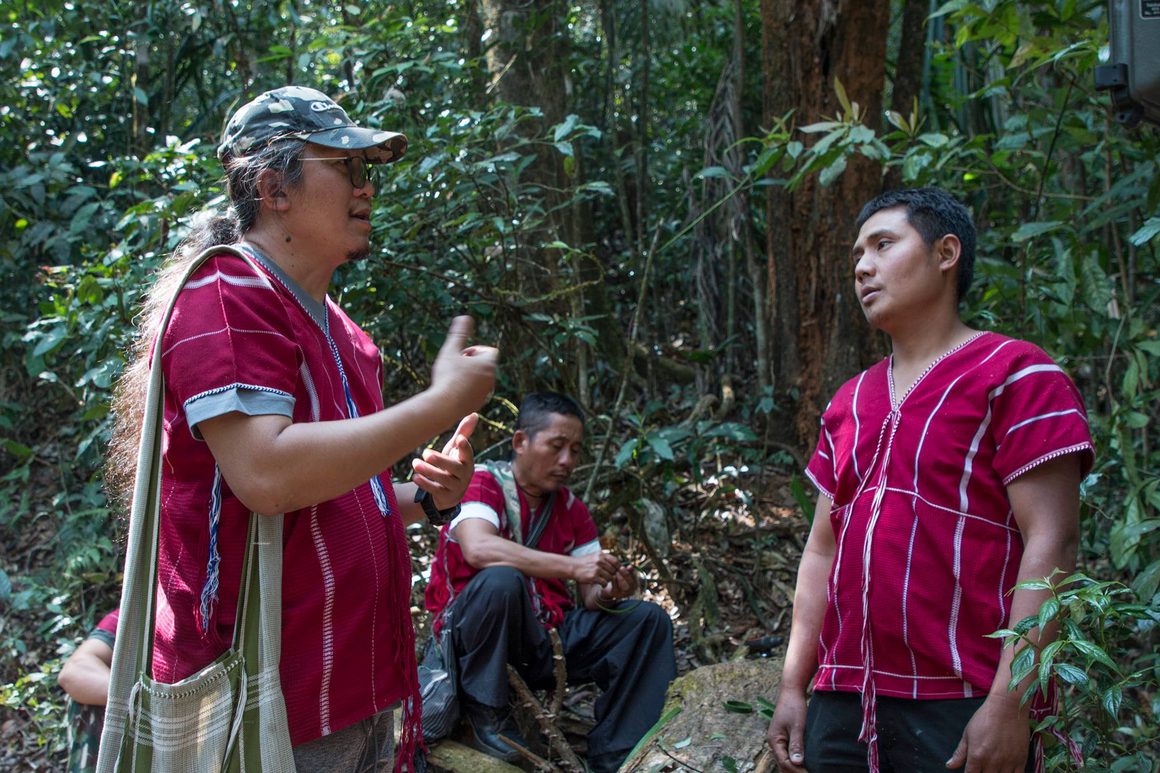 Karen conservation team members talking together in the forest during fieldwork